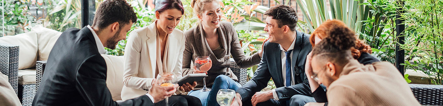 Six business people sitting around a table after work
